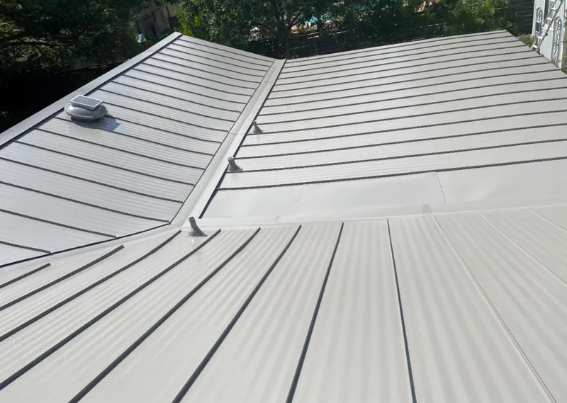 Solar attic fan installed on a metal roof for Roof Ventilation in Brecksville